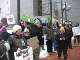 Protesters with signs on People's Plaza