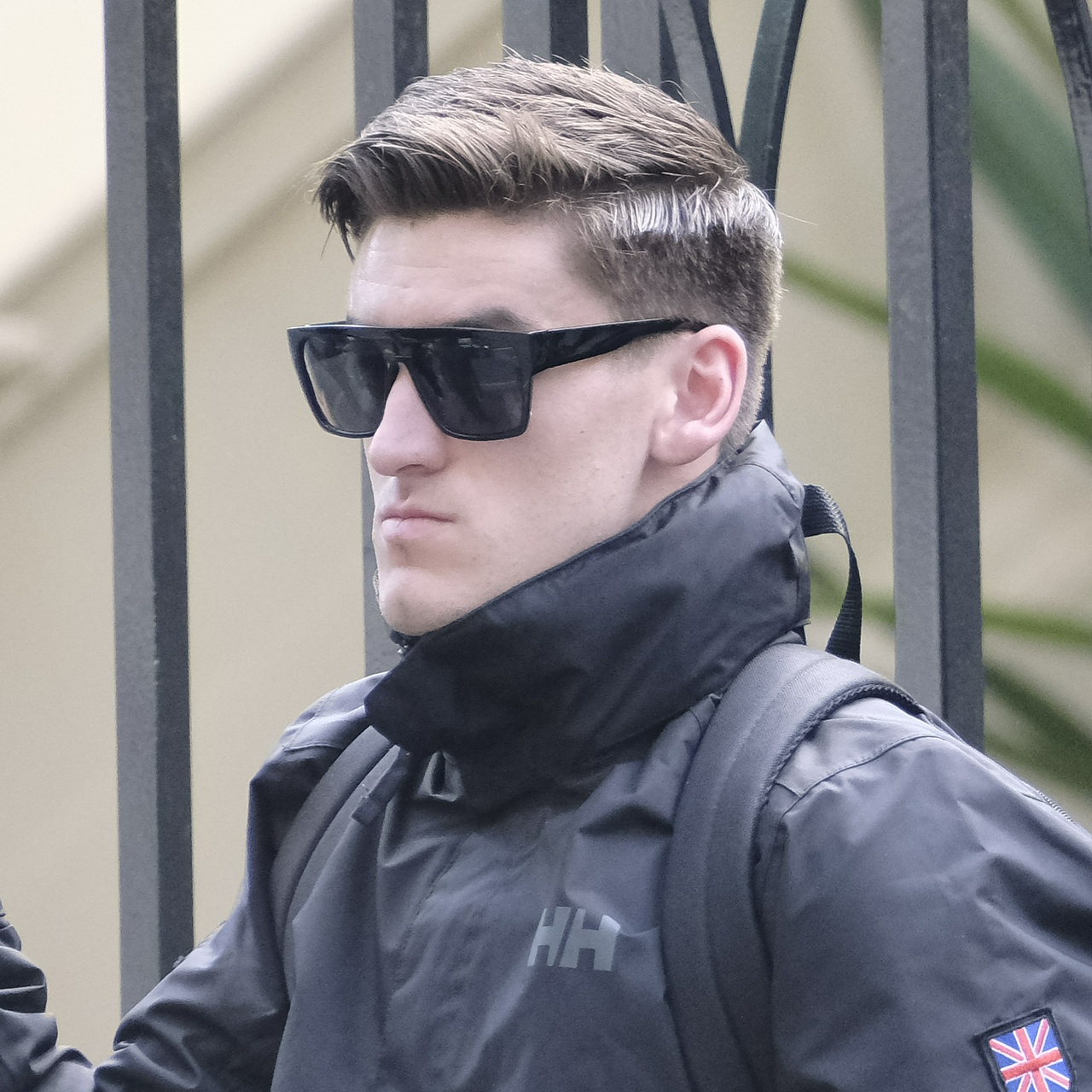 Roberts from another angle, showing his oversized chin resting uncomfortably on his tall jacket collar