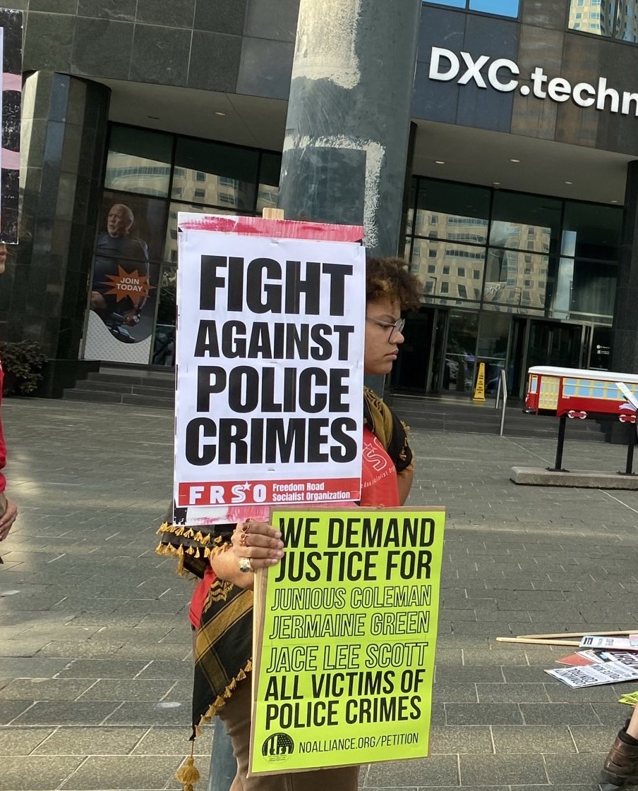 Protester holds signs for police accountability outside New Orleans Police Department headquarters during a rally on October 6.