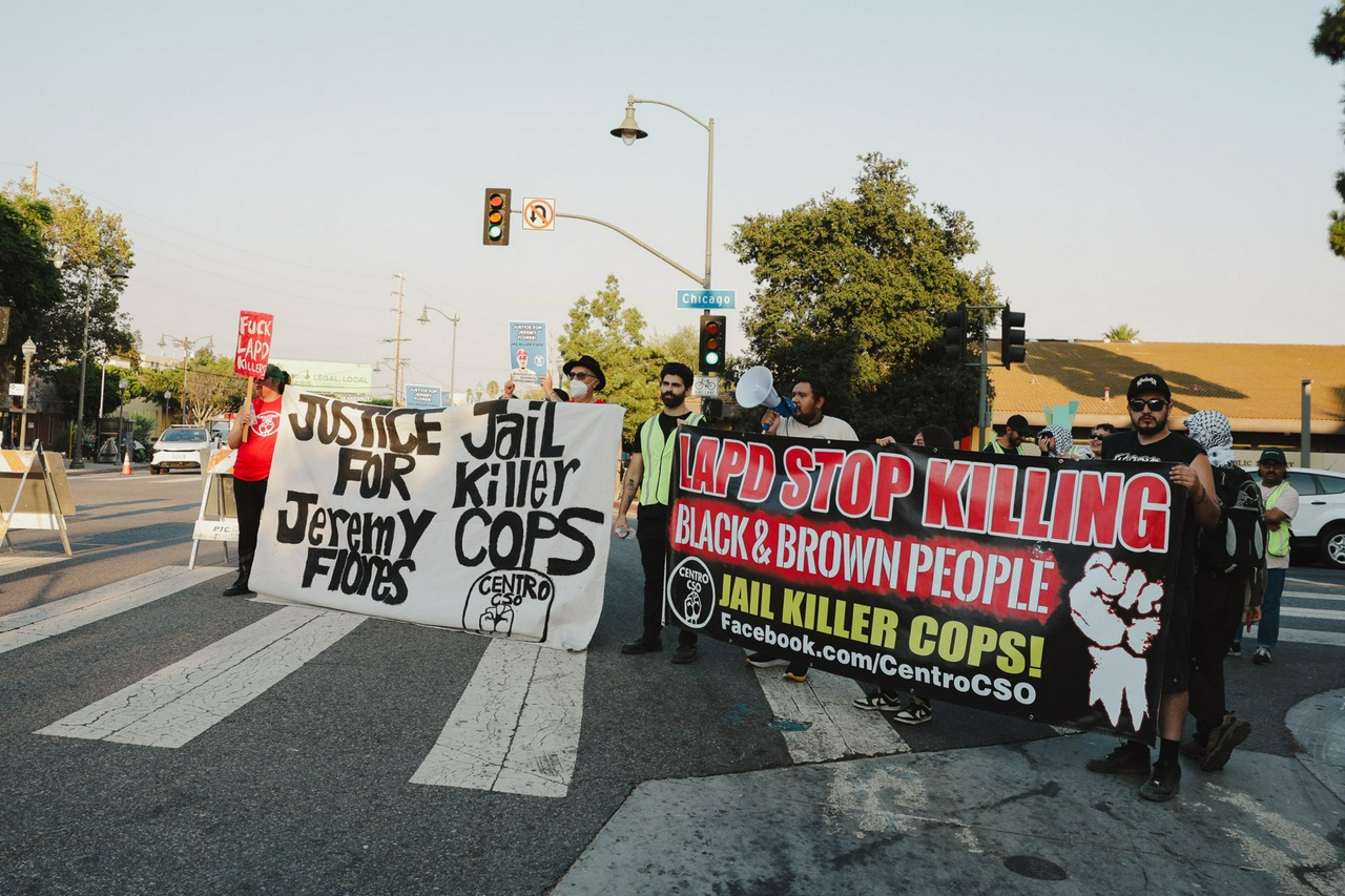 A group of protesters holding banners.