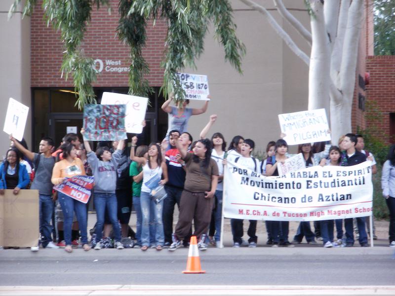 MEChA students protesting outside a school