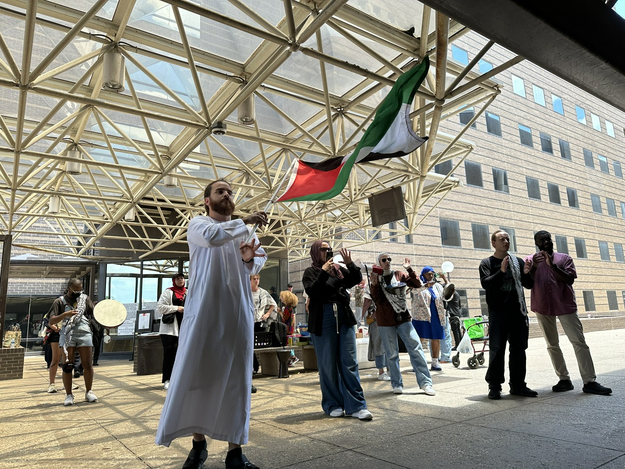Protesters holding Palestine flags.