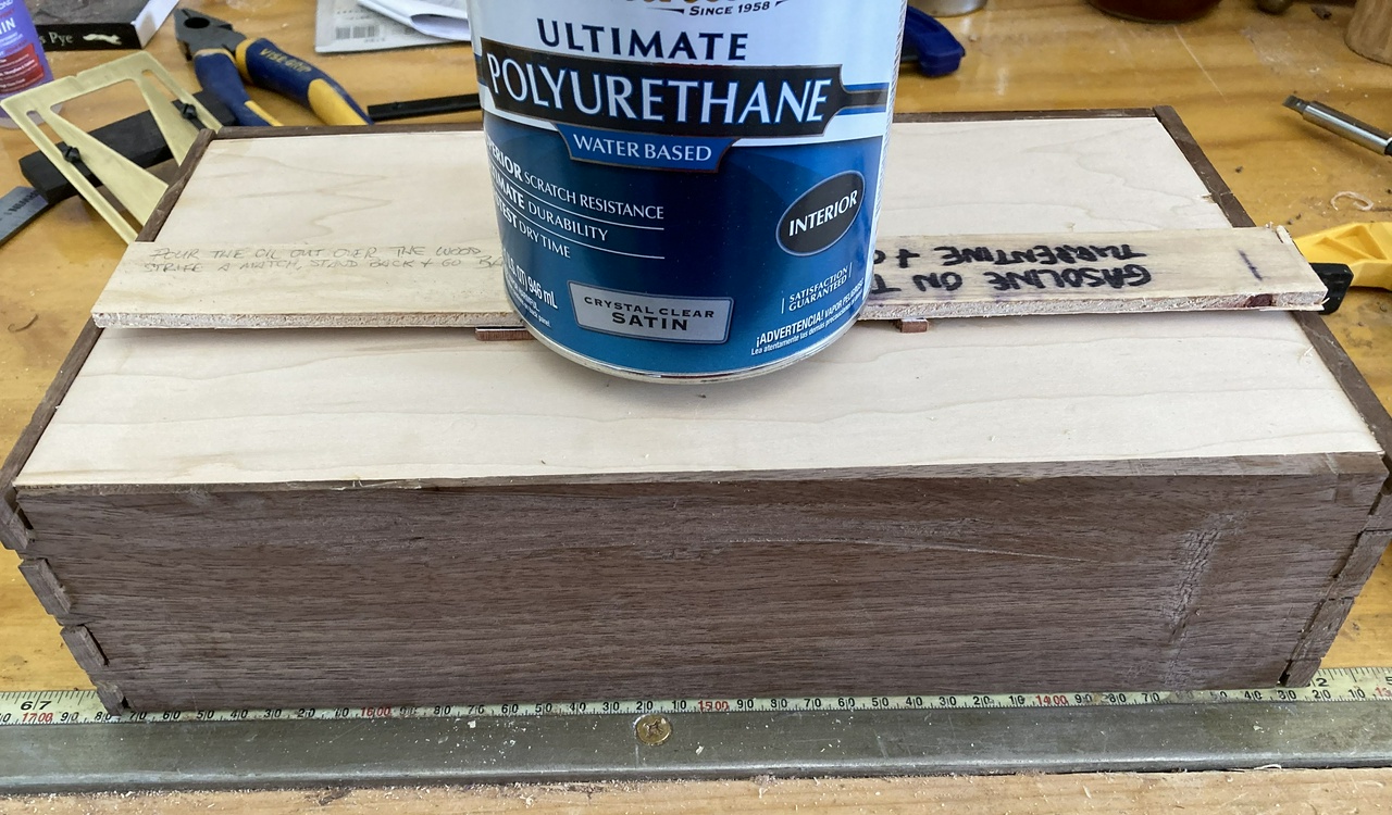 clamping the letters to the front of the box with a can of polyurethane as a weight