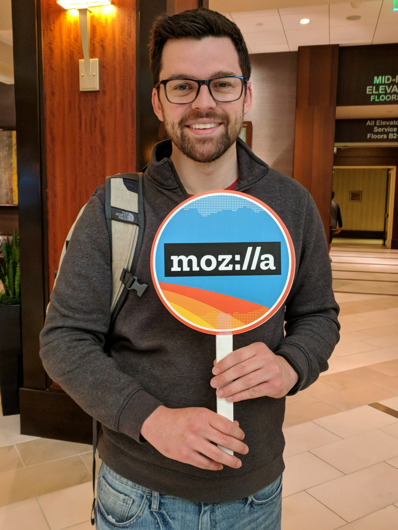 Me holding a sign with the Mozilla logo on it