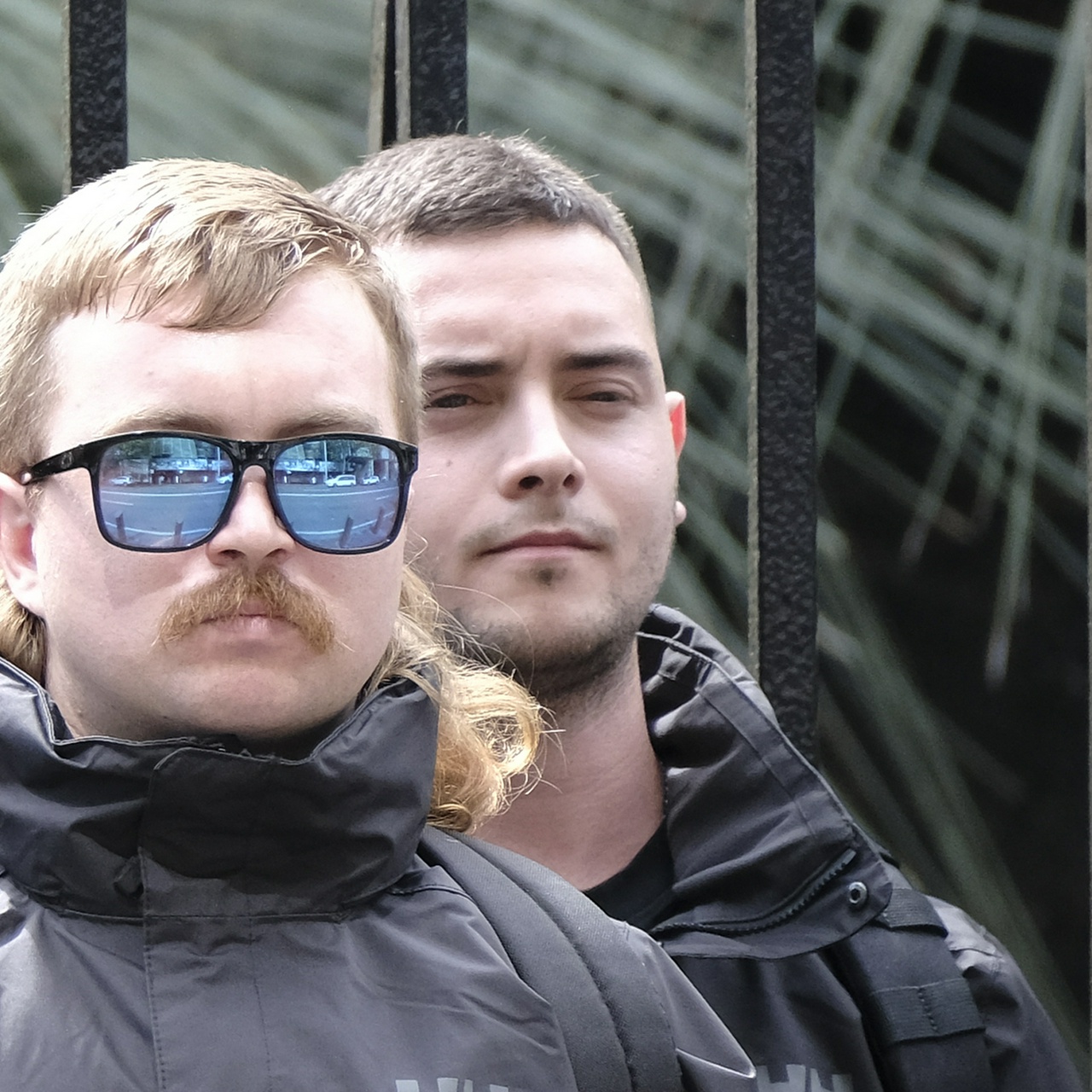 The same man squinting in the back row