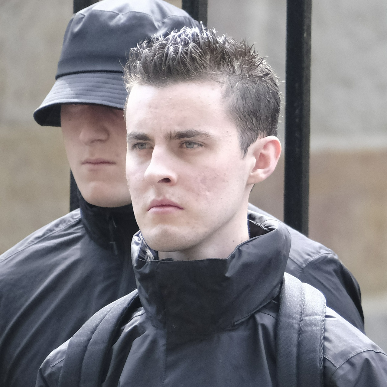 A young white man with a large pointy head, gelled spiked hair, unusually large nostrils, and hazel eyes