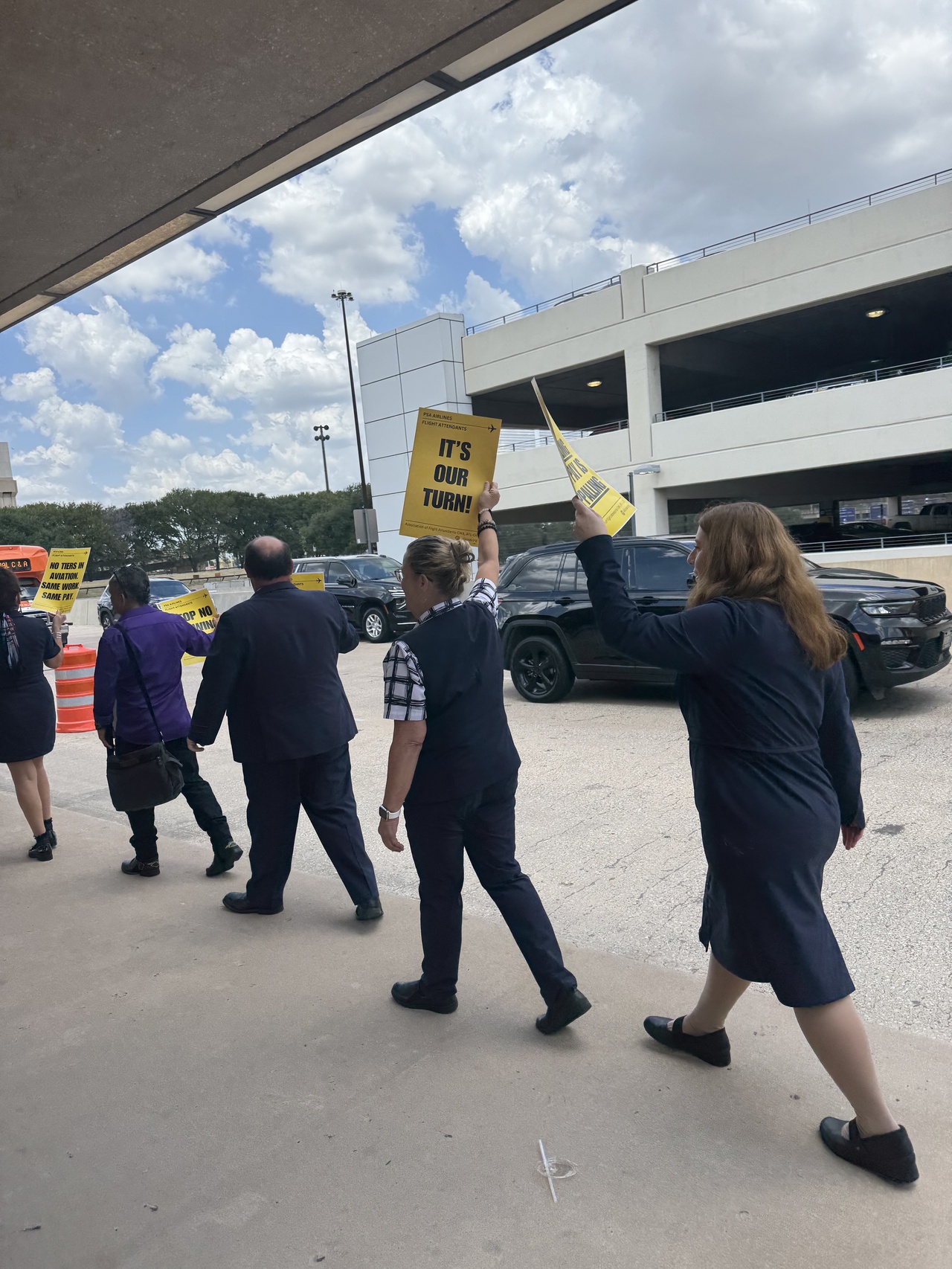 Flight attendants picket outside of DFW airport.