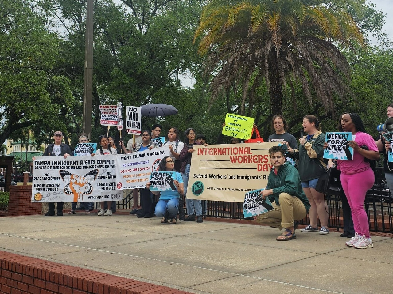 Tampa workers celebrate May Day during a thunderstorm