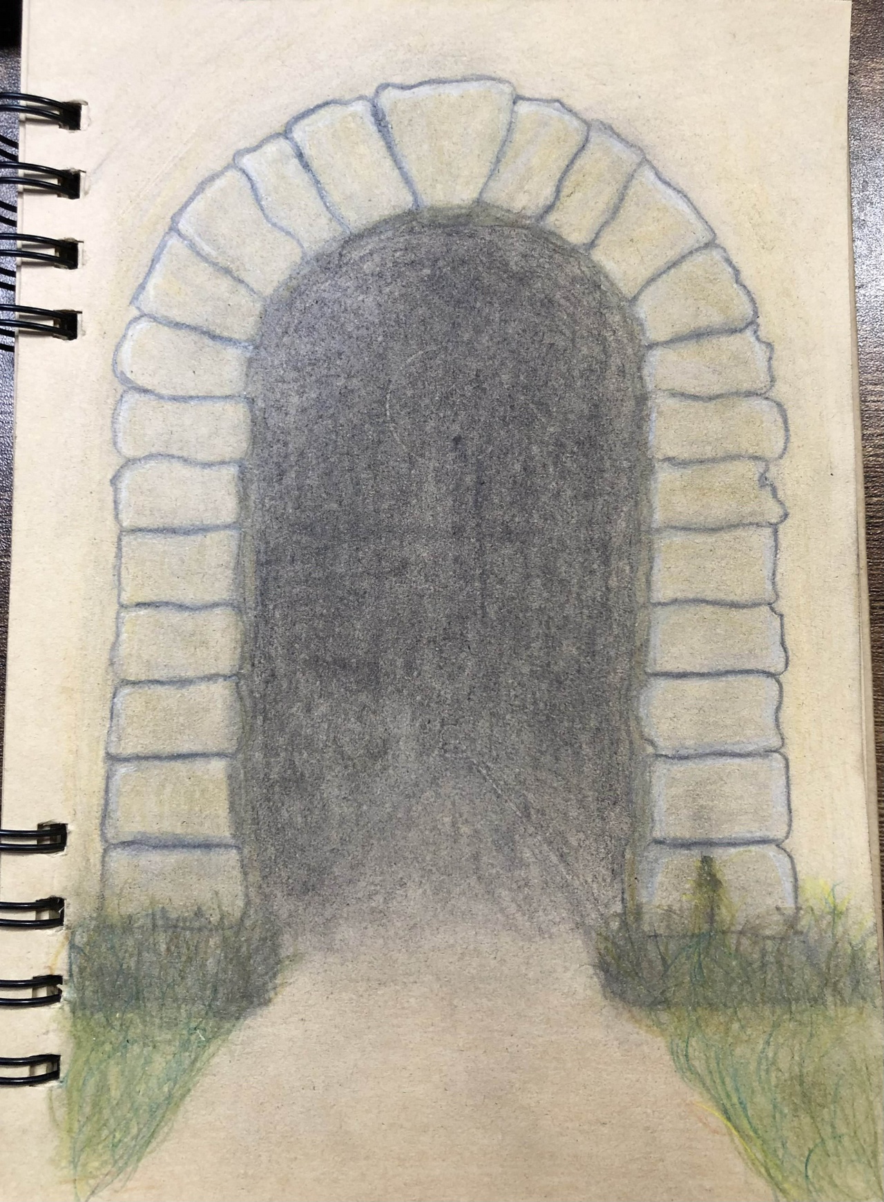 a sketch of a tunnel going into a mountain. the opening is built of stone. 