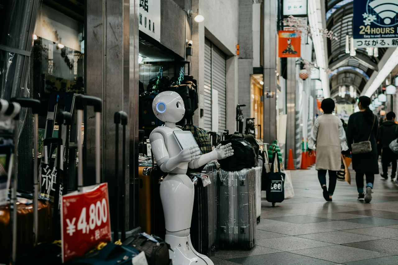 by Lukas from Unsplash, a white robot standing in front of a store
