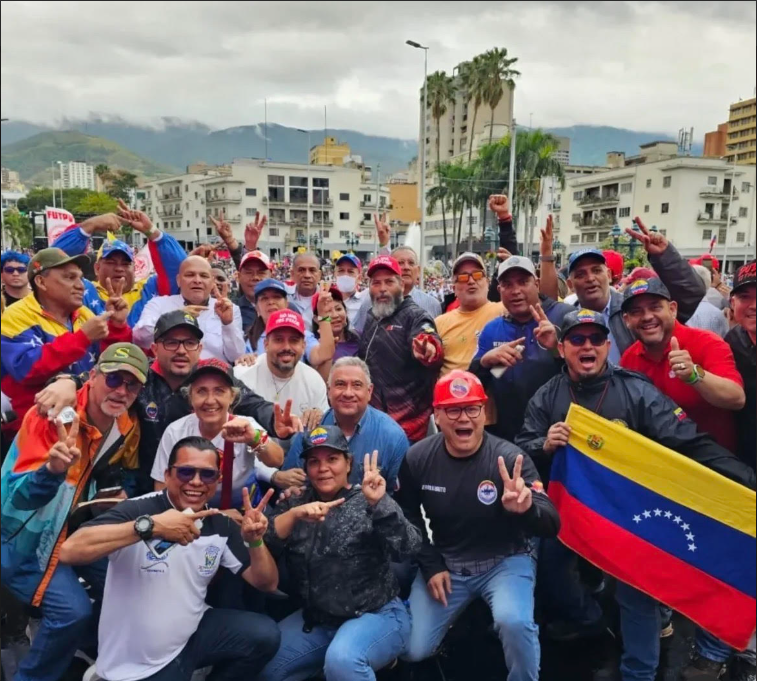 Trade union leaders show Maduro's  in-custody hand signal.