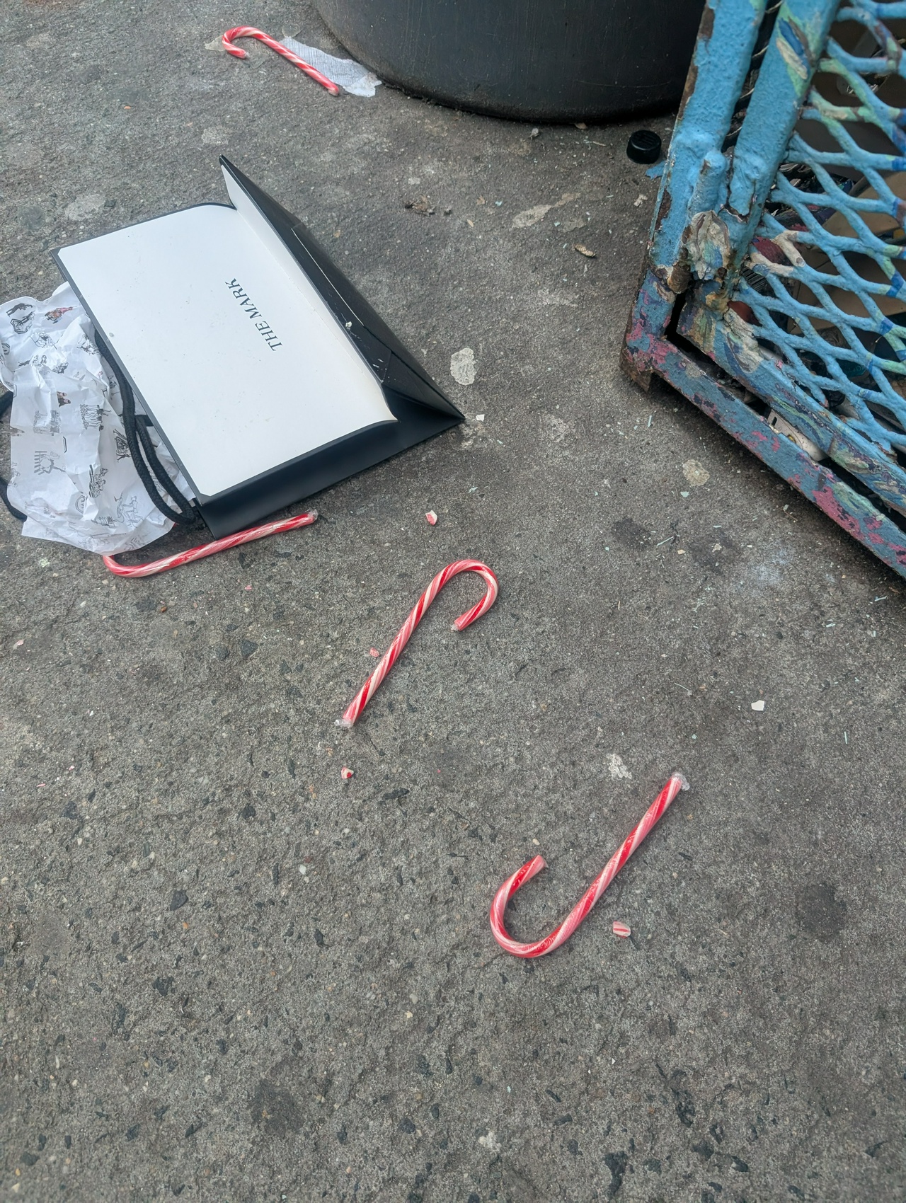 found trash, featuring three candy canes leading from a shopping bag that says "The Mark"