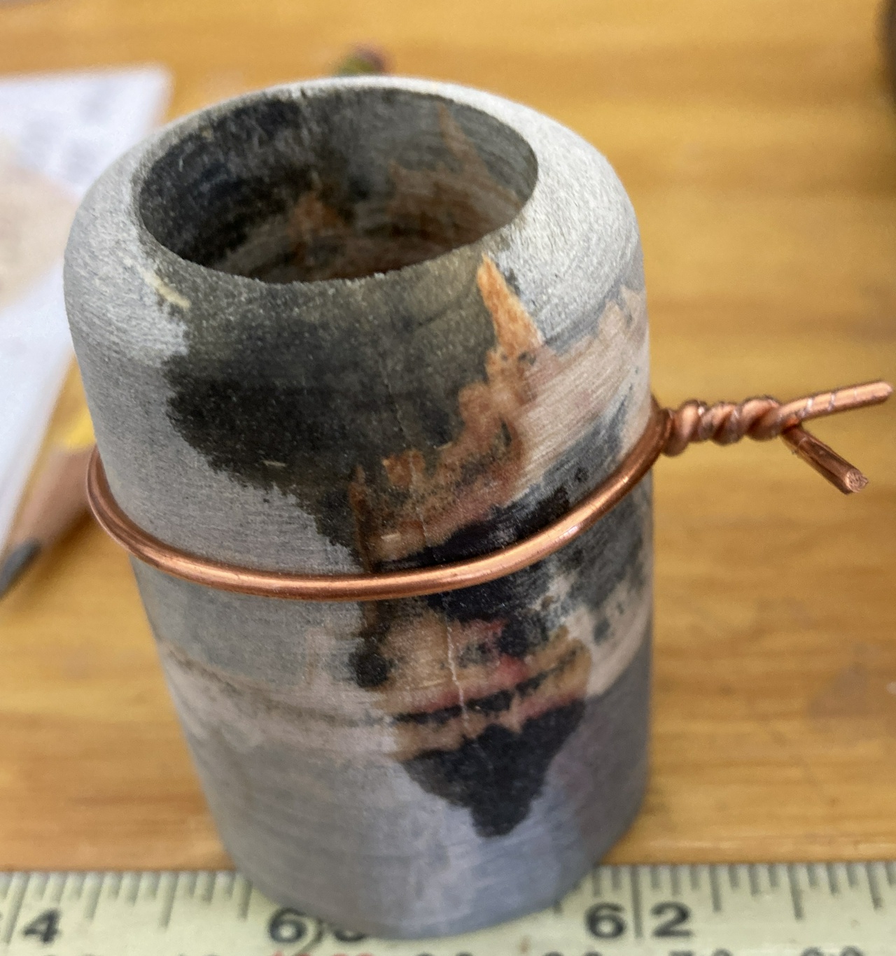 cracked and mended shaker with a piece of 12 gauge copper wire holding it together while the glue dried