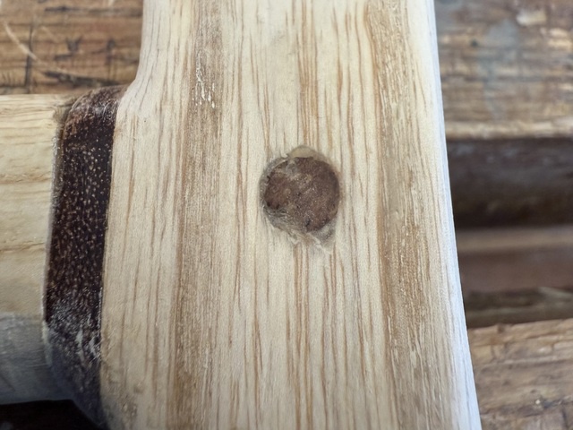 The end of the peg, sawn flush with the side of the handle, with a mixture of ash sawdust and CA glue around it, filling any gaps