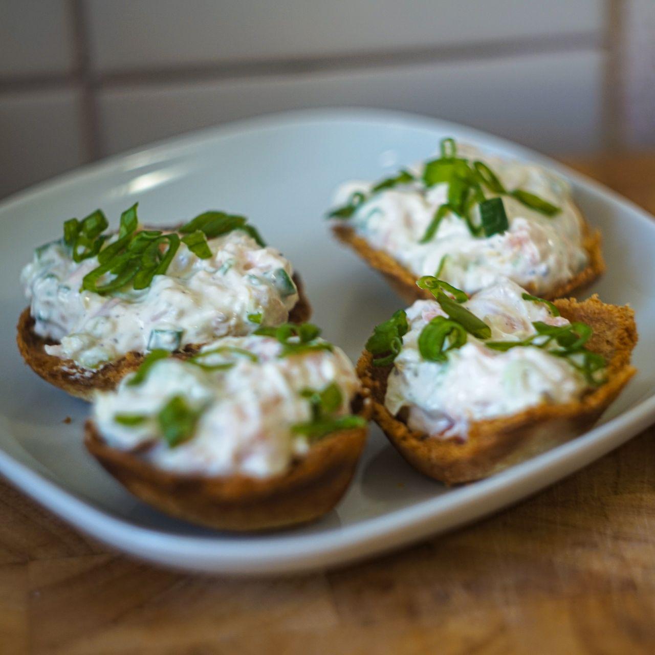 small crispy bread bowls filled with salmon and cream