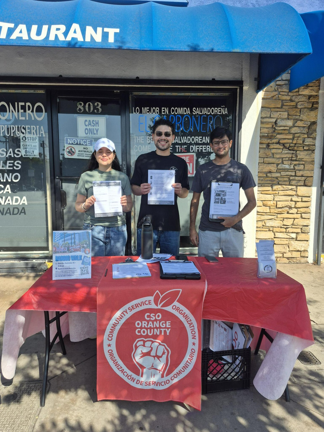 Community members table to hand out information packets and resources to immigrant communities. | Fight Back! News Community members table to hand out information packets and resources to immigrant communities.