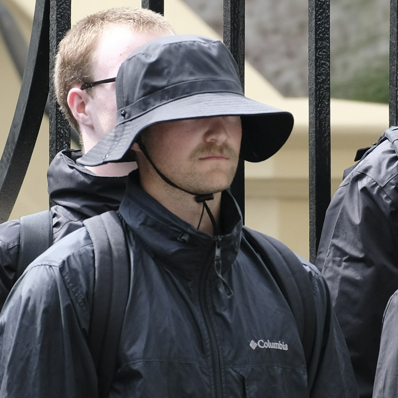 The ear of that same guy, who has pimples on his forehead