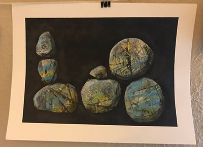 acrylic on paper: some shapes - rocks? -in yellow and blue and green, with texture and weight, on a black background. 