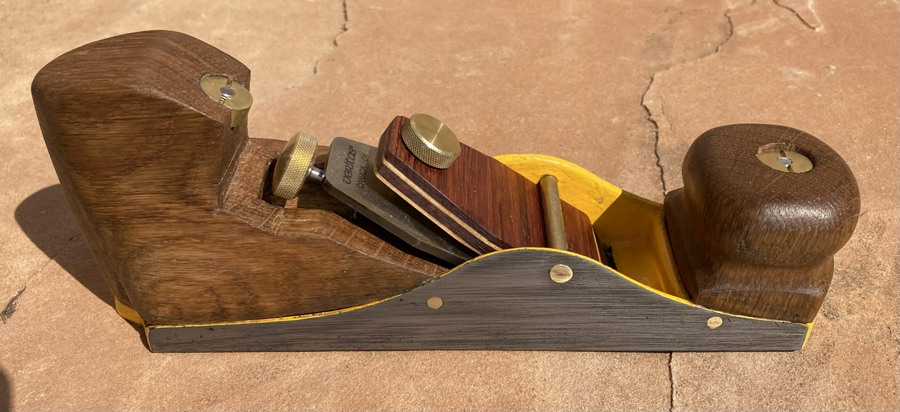 A low-angle infill plane with yellow-painted metal bits and white oak furniture, viewed from the right side