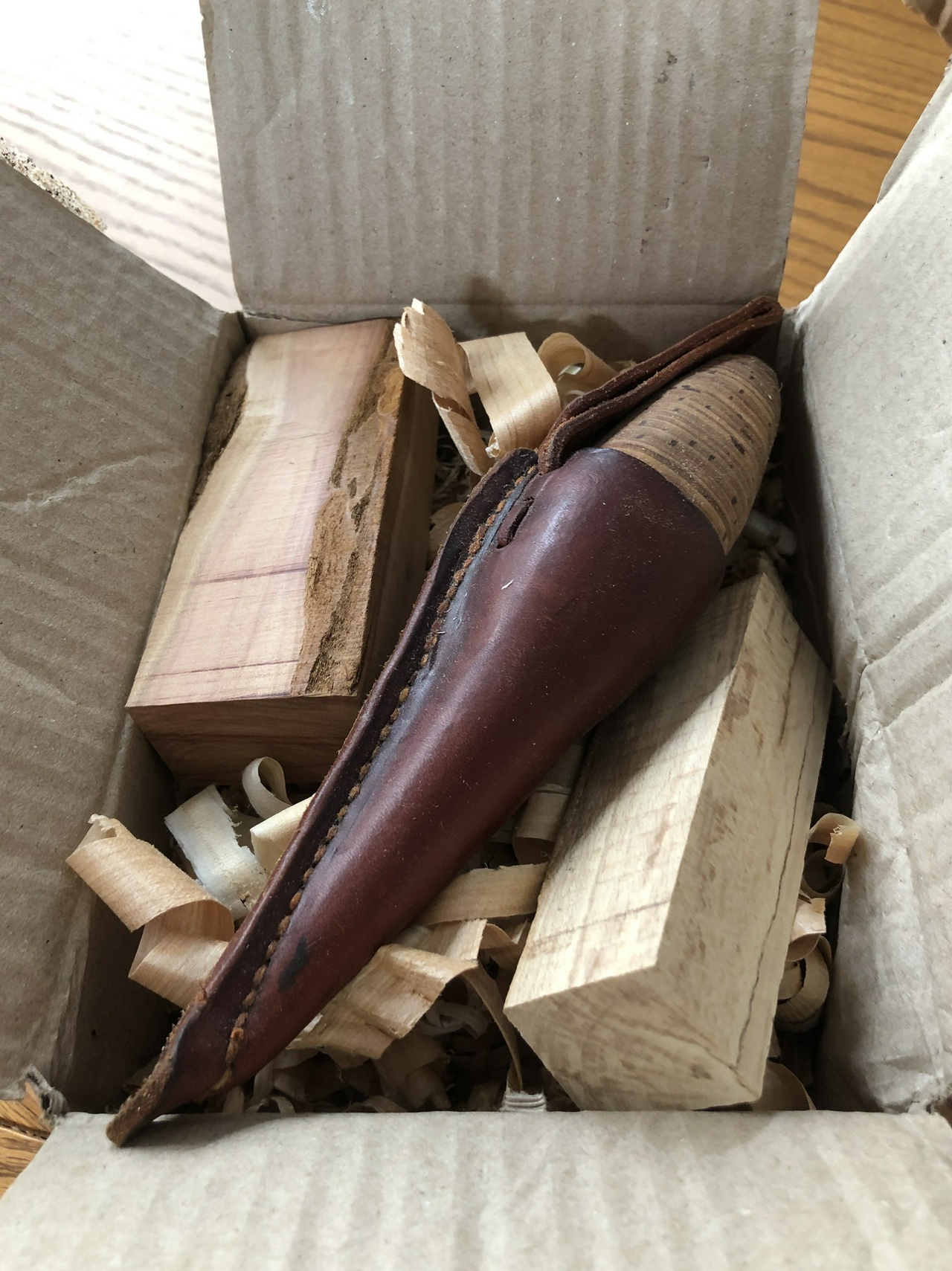 Knife with sheath, and packaging material from Mads