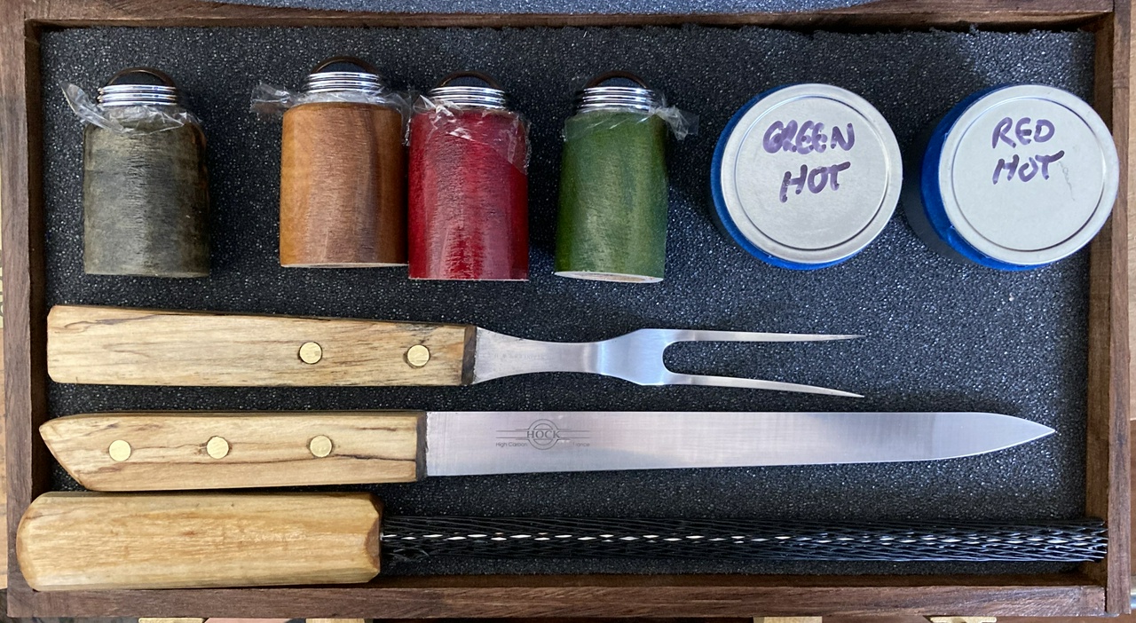 shakers, spare chile, and tools arranged in the case