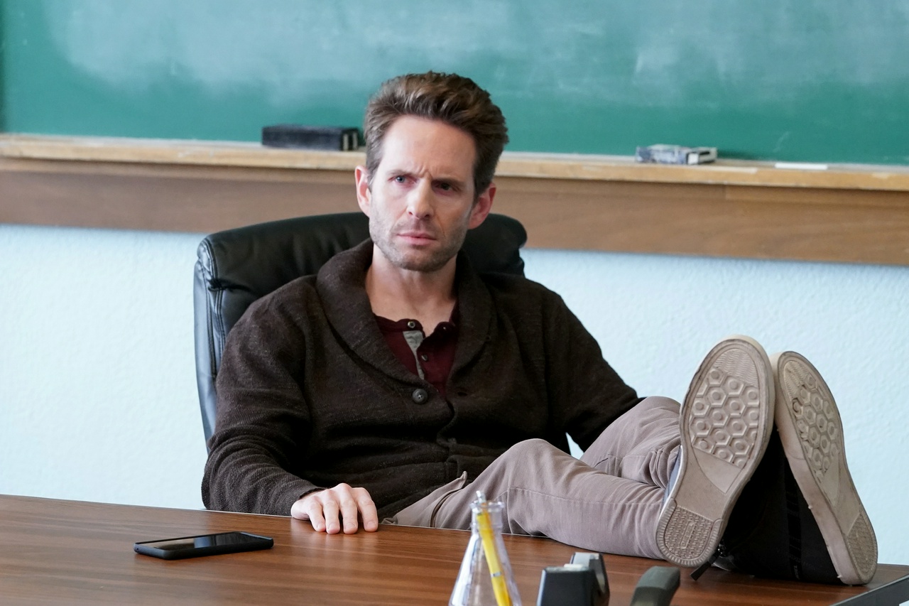 Glenn Howerton in his massage chair with his feet on the desk