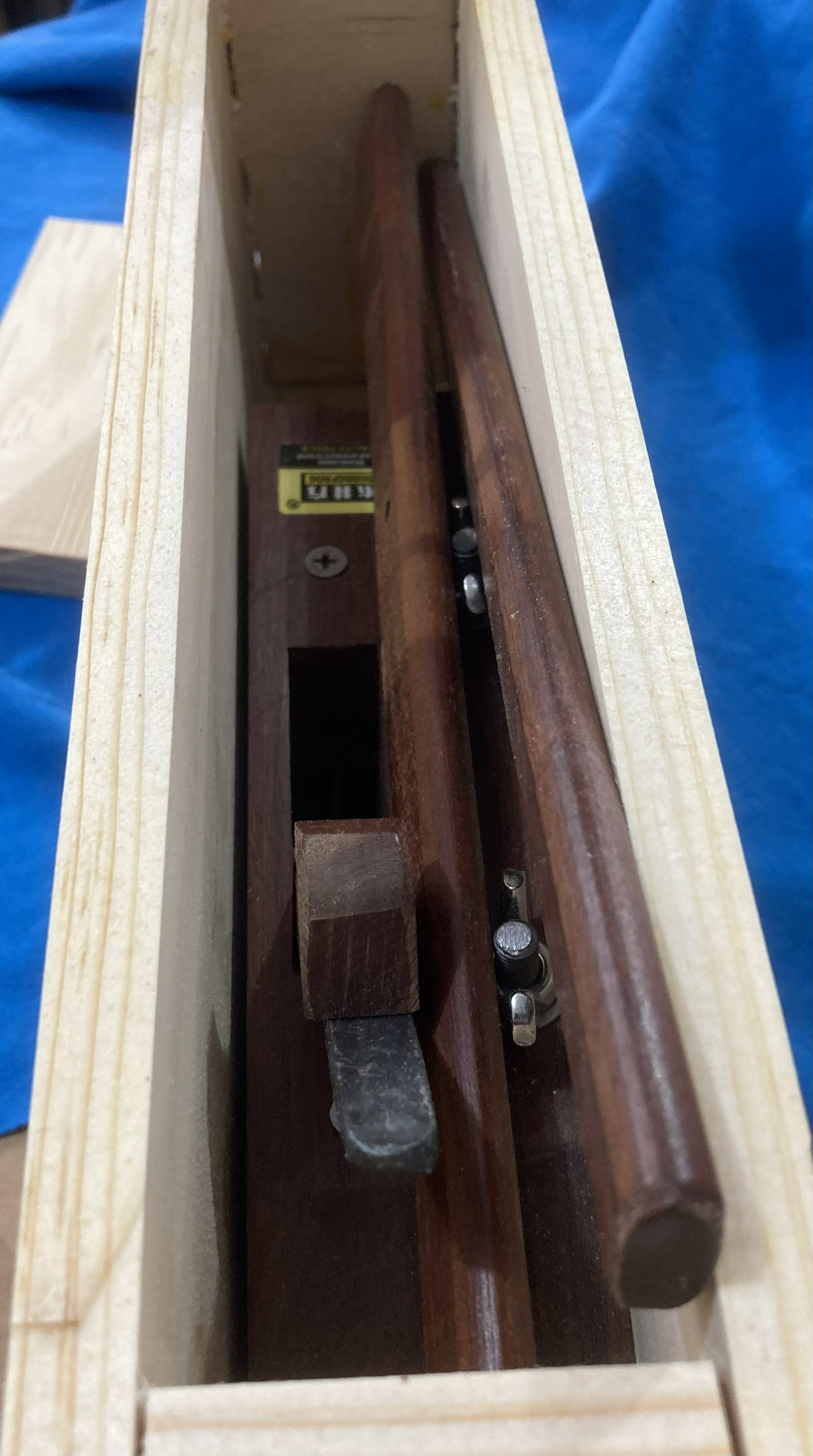 Open storage box, showing the plane, fence and arms in the box