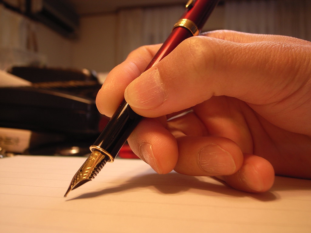 Up-close image of a person holding a fountain pen.