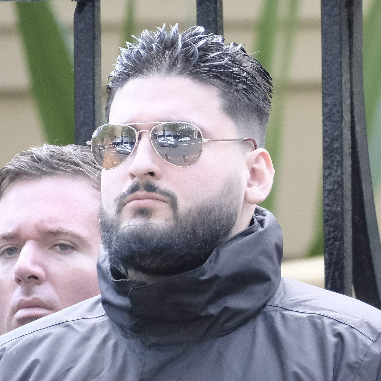 The same guy from an angle that shows the grey flecked through his beard and the weird point on the side of his ear