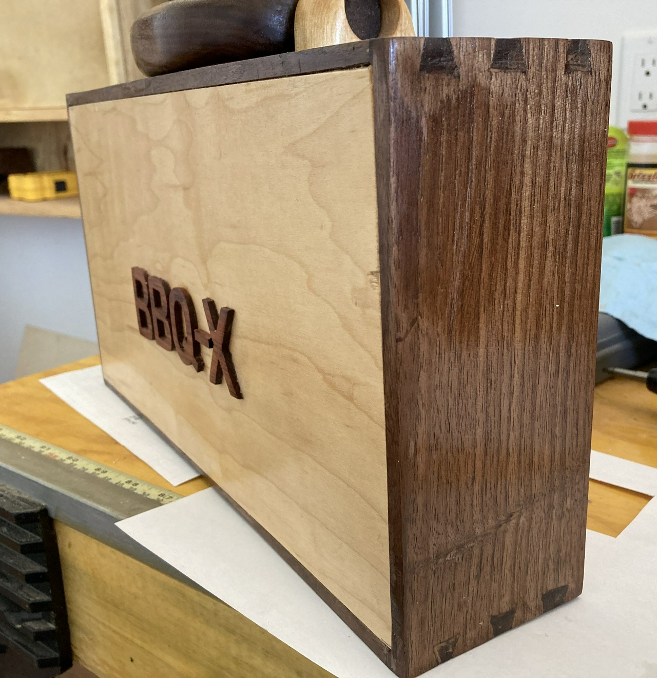 oblique view of the briefcase, showing the letters on the front and the dovetails on the sides of the case