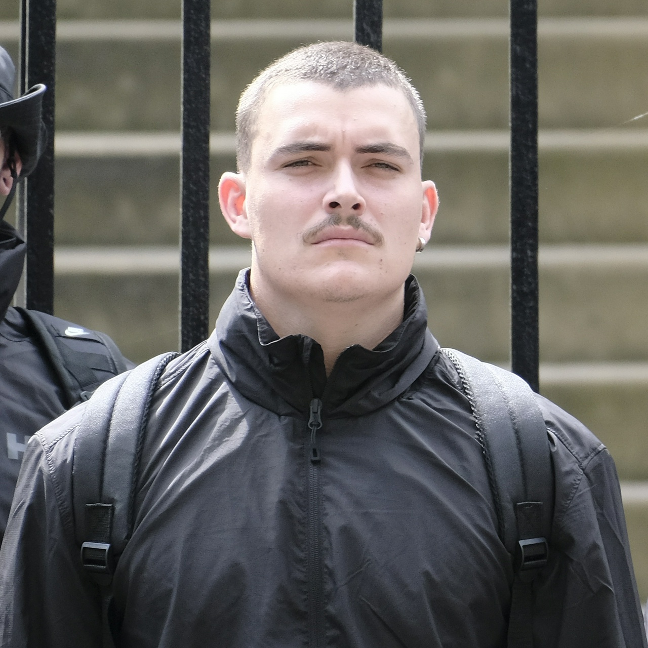 The same man from front-on, showing that he has a single thick silver earring in his left ear