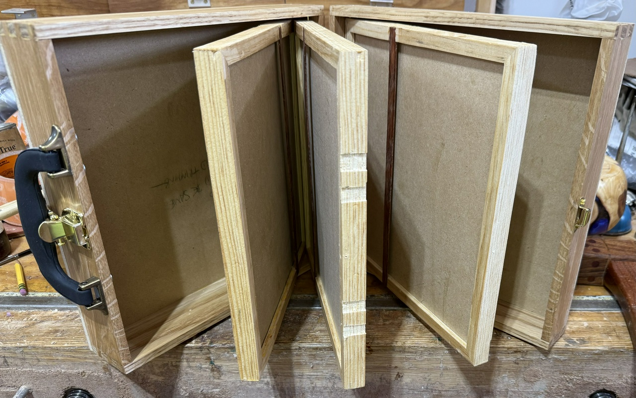 Table saw blade storage case completely open, showing all of the carriers