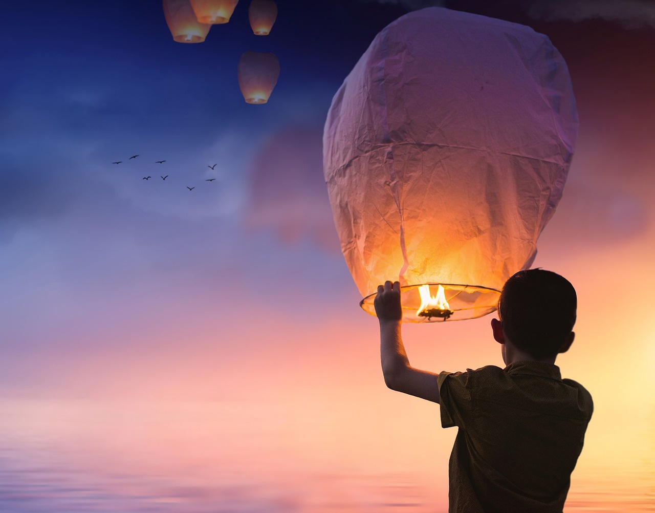 Child launching a candle balloon